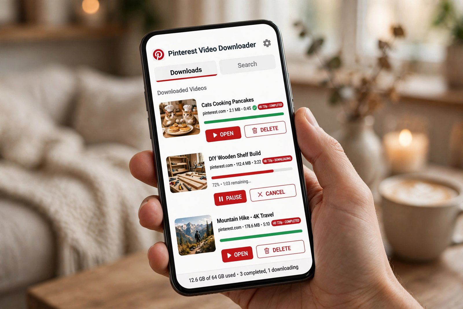 Hand holding a smartphone showing a Pinterest video downloader app with download progress bars and quality labels